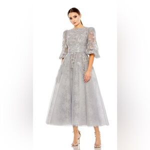 MAC DUGGAL COCKTAIL 20418
Platinum lace beaded gown with puffy sleeves